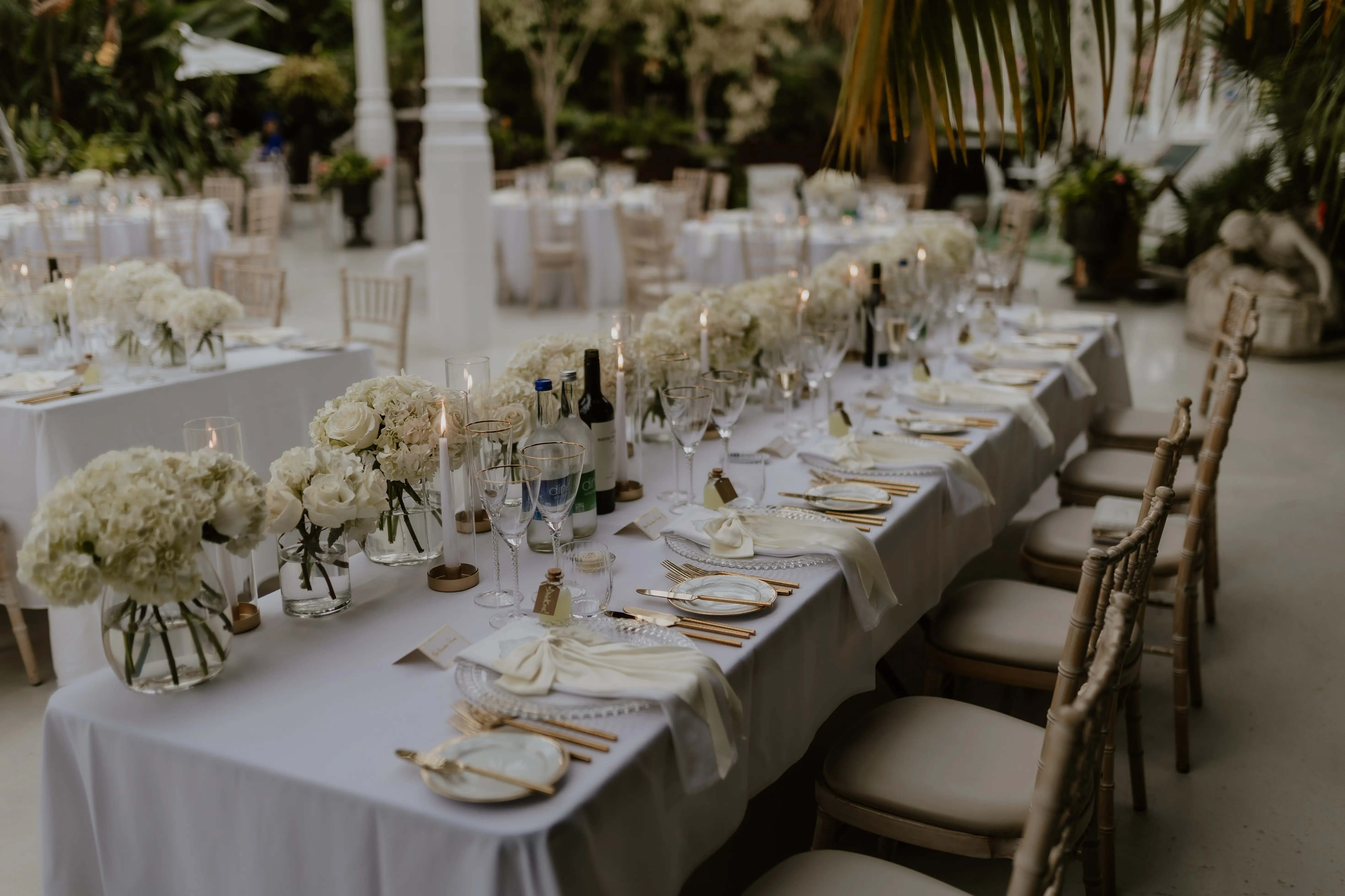 Sefton Park palm house Liverpool wedding venue set up with long guest tables and white wedding flowers